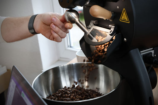 Kaffeeröster mit offener Klappe aus der die fertigen Bohnen herausfallen